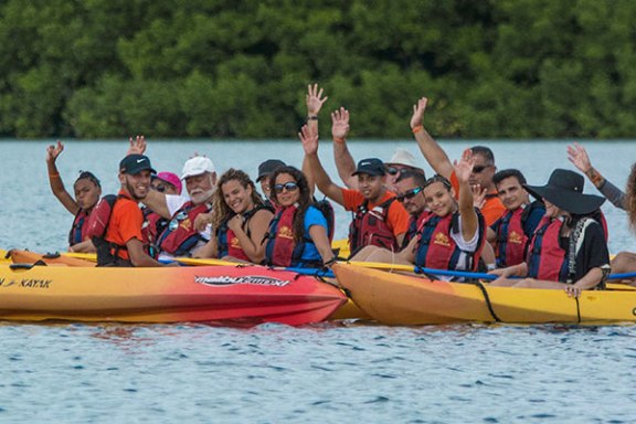 Group of kayakers waving to the camera
