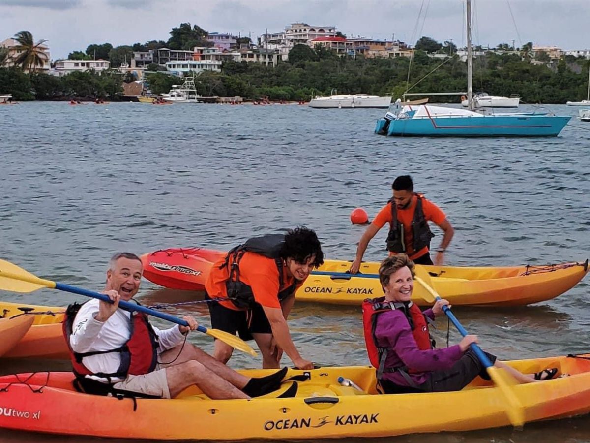 a group of people in a small boat in a body of water