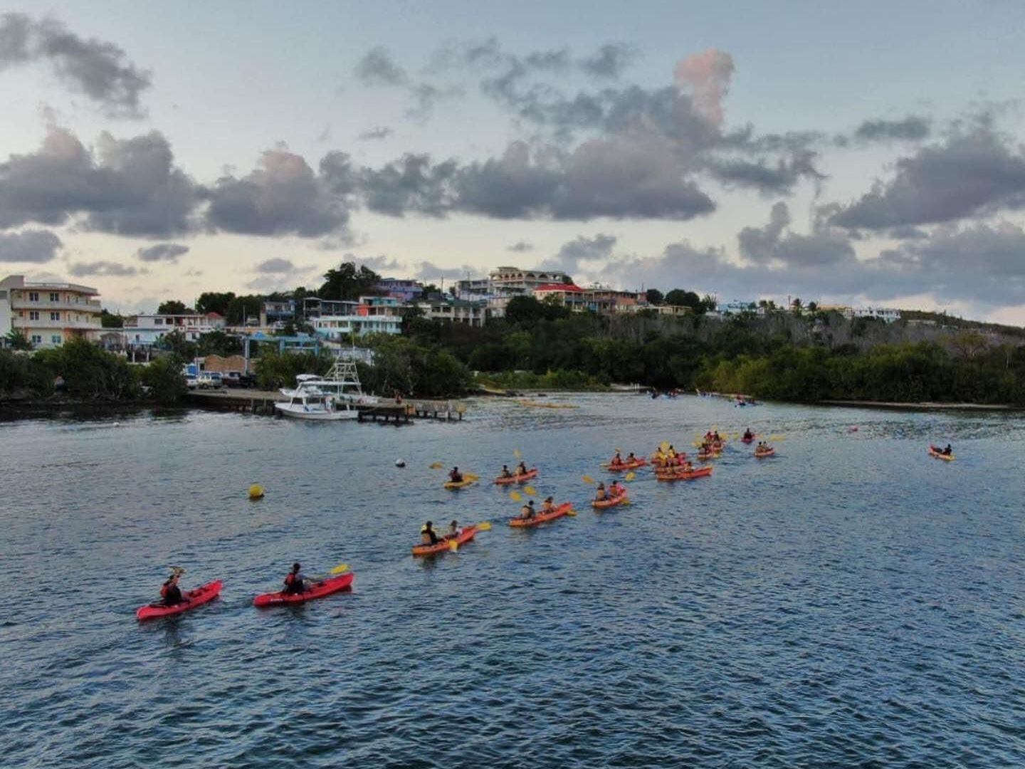 a group of people on a boat in a large body of water