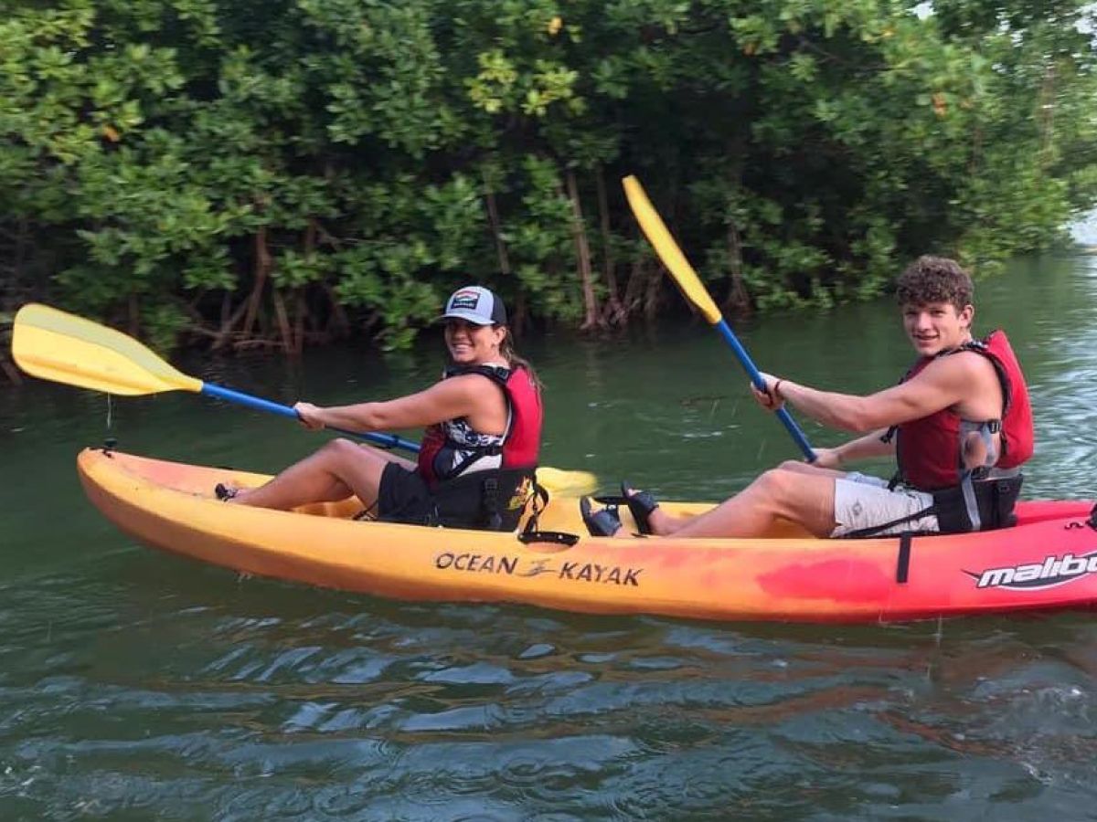 a person riding on the back of a boat in the water