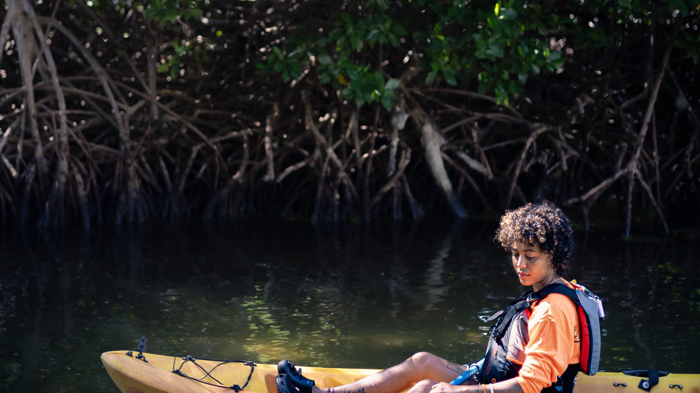 a man riding on the back of a boat in the water