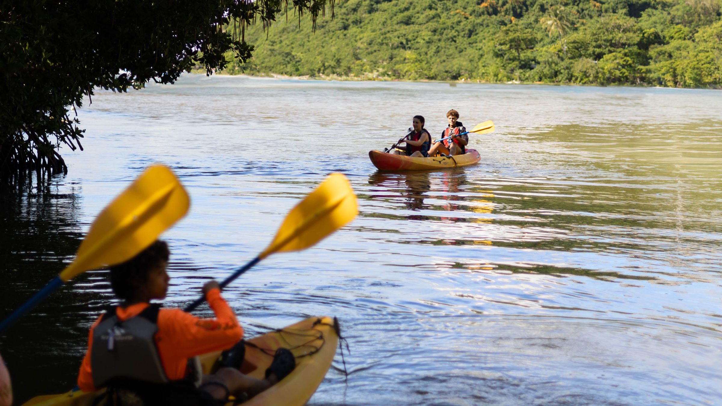 a group of people in a small boat in a body of water