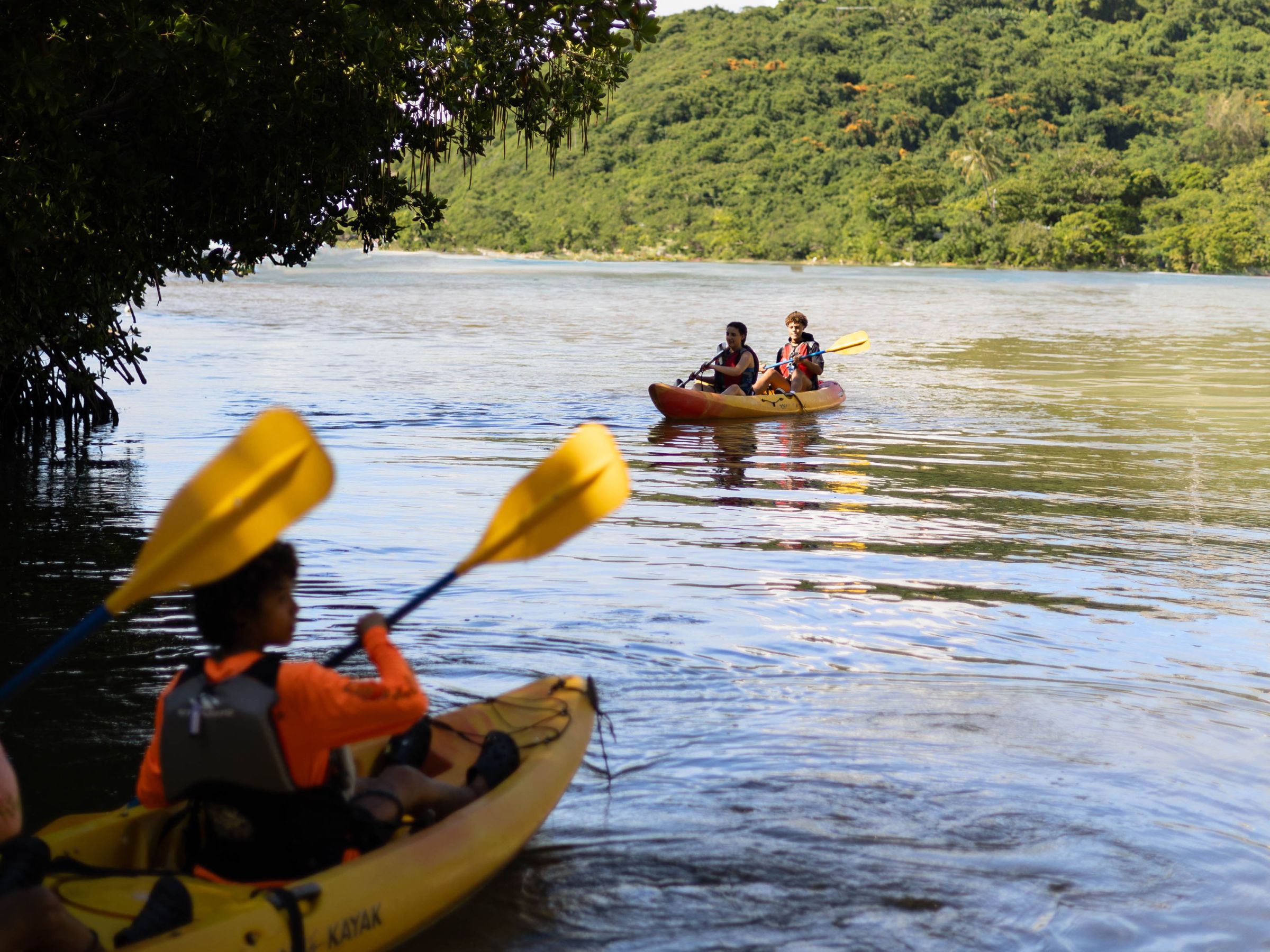 a group of people in a small boat in a body of water