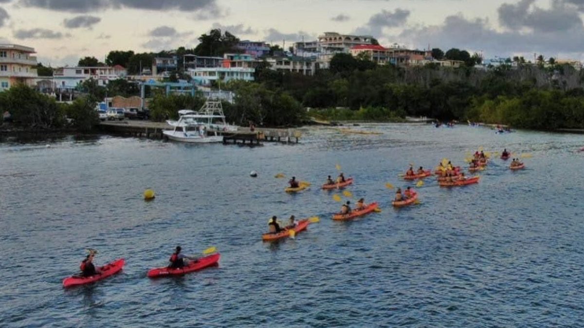 a group of people on a boat in a large body of water
