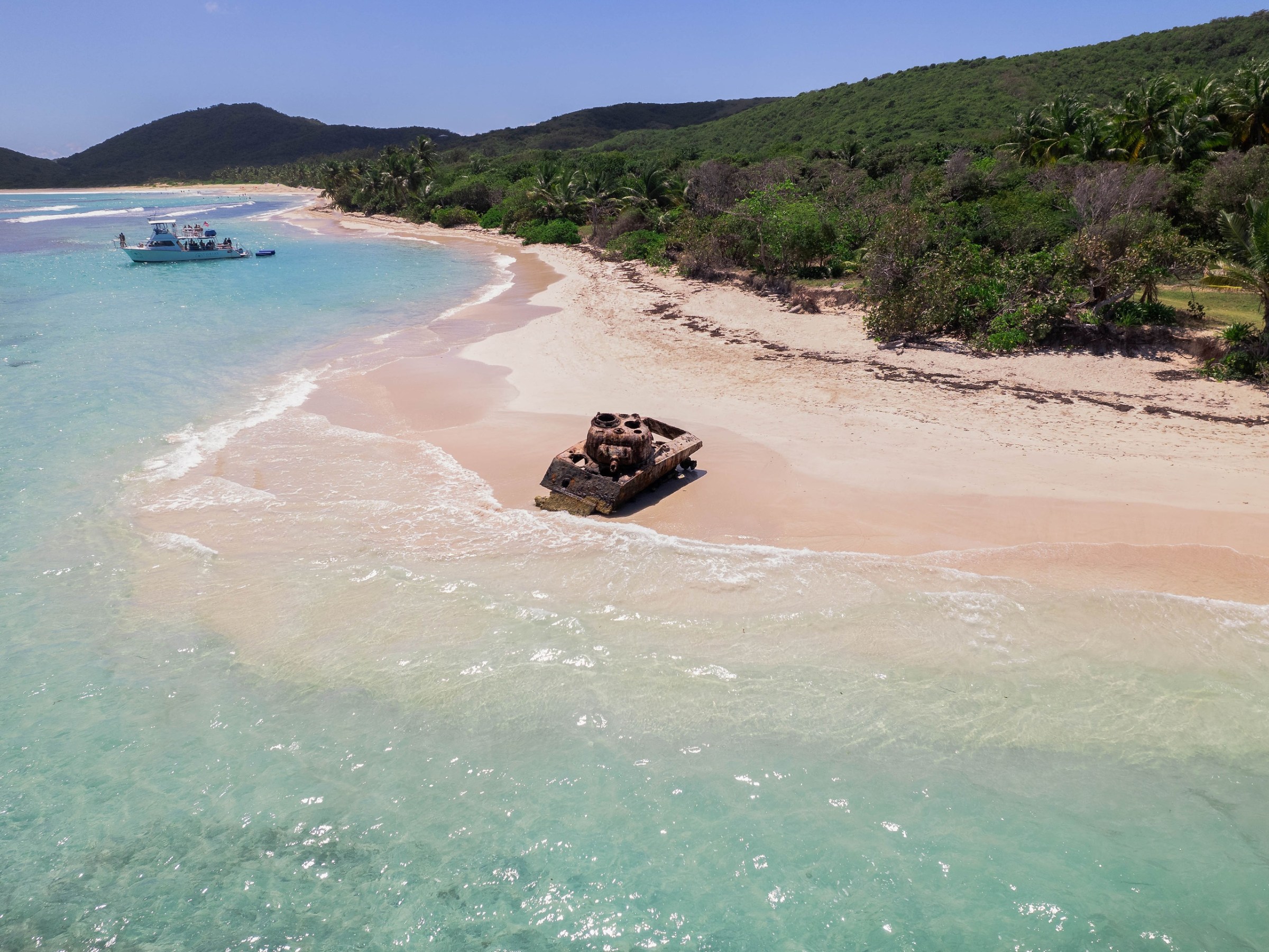a group of people on a beach near a body of water