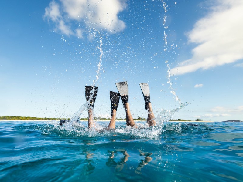 a girl riding a wave on a surfboard in the water